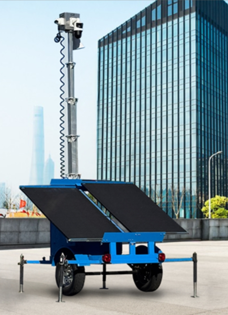 Mobile CCTV surveillance trailer with raised camera mast near a commercial building